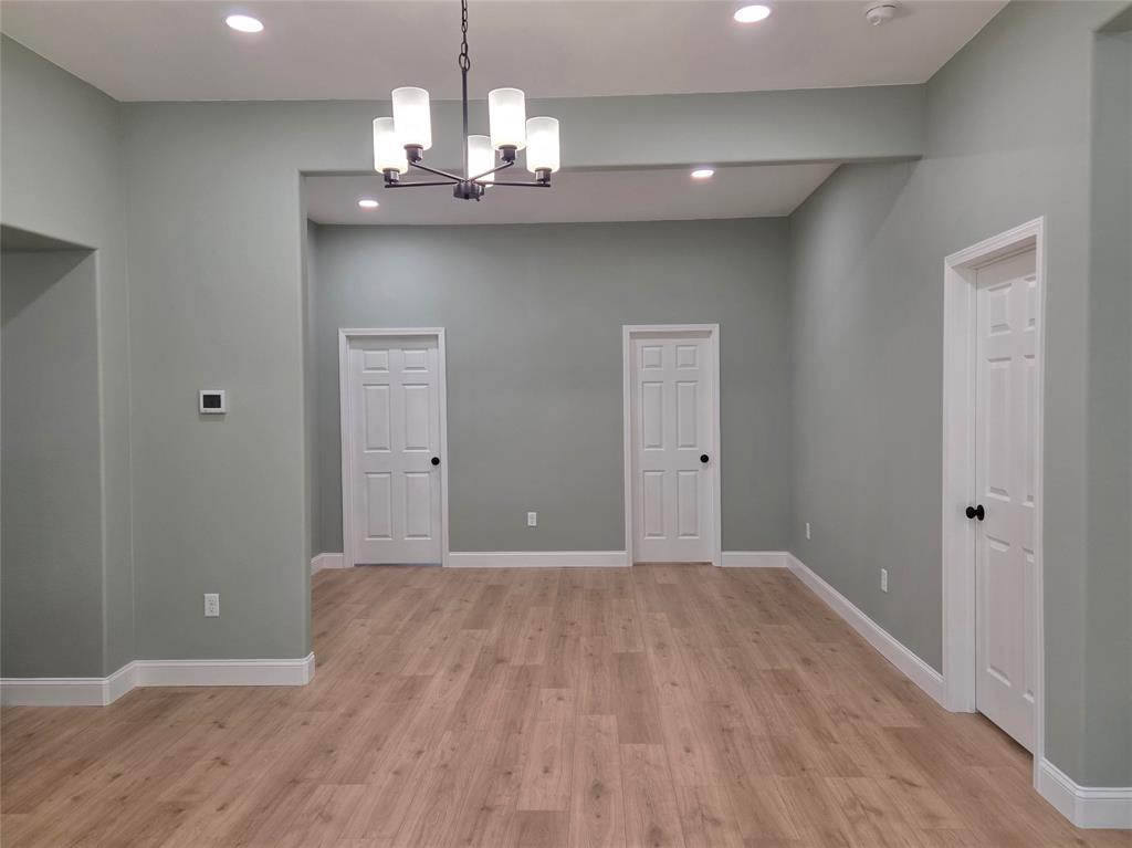 1745 East Cherry Street Paris, TX 75460 - Photo 13 of 40 a view of a chandelier in big room and wooden floor
