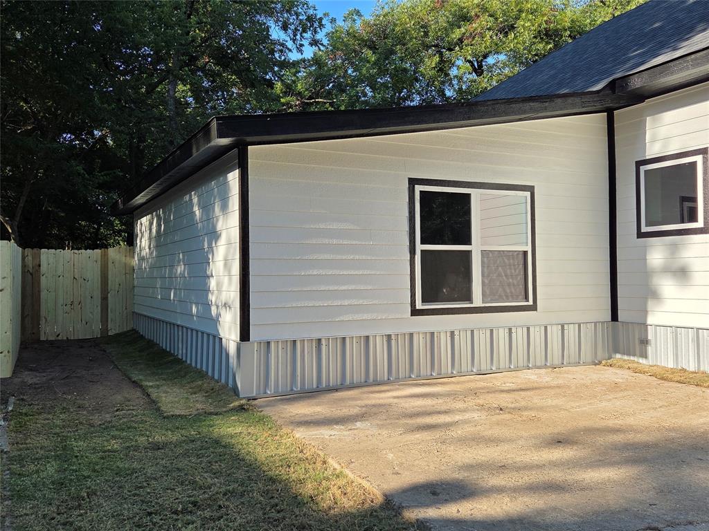 1745 East Cherry Street Paris, TX 75460 - Photo 2 of 40 a view of a house with backyard and trees