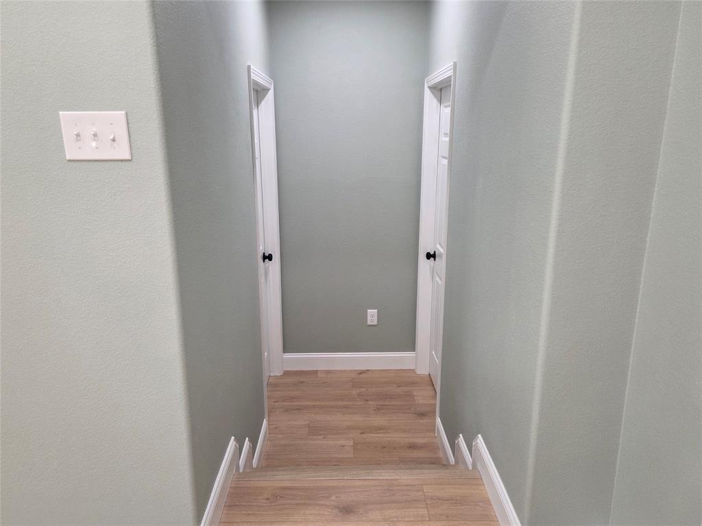 1745 East Cherry Street Paris, TX 75460 - Photo 22 of 40 a view of a hallway with wooden floor