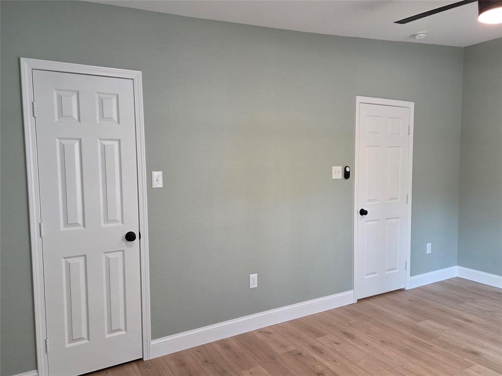 1745 East Cherry Street Paris, TX 75460 - Photo 24 of 40 a view of an empty room with wooden floor