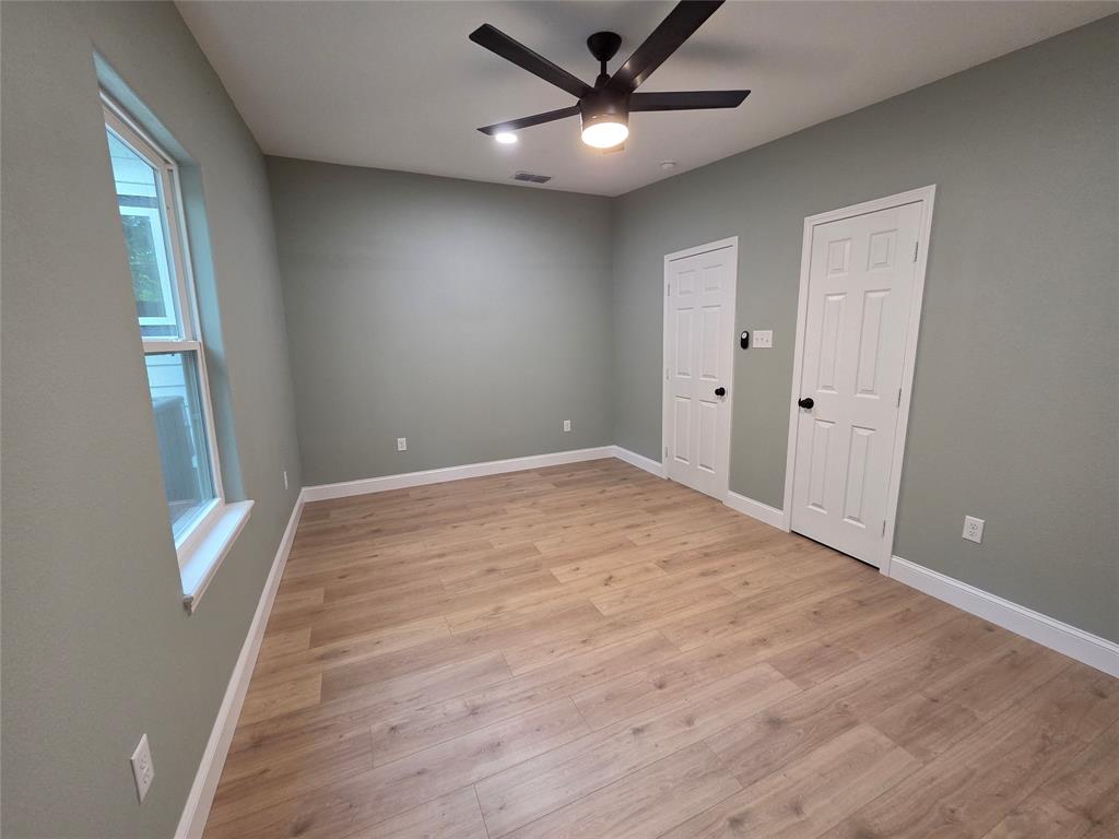 1745 East Cherry Street Paris, TX 75460 - Photo 29 of 40 an empty room with wooden floor and windows