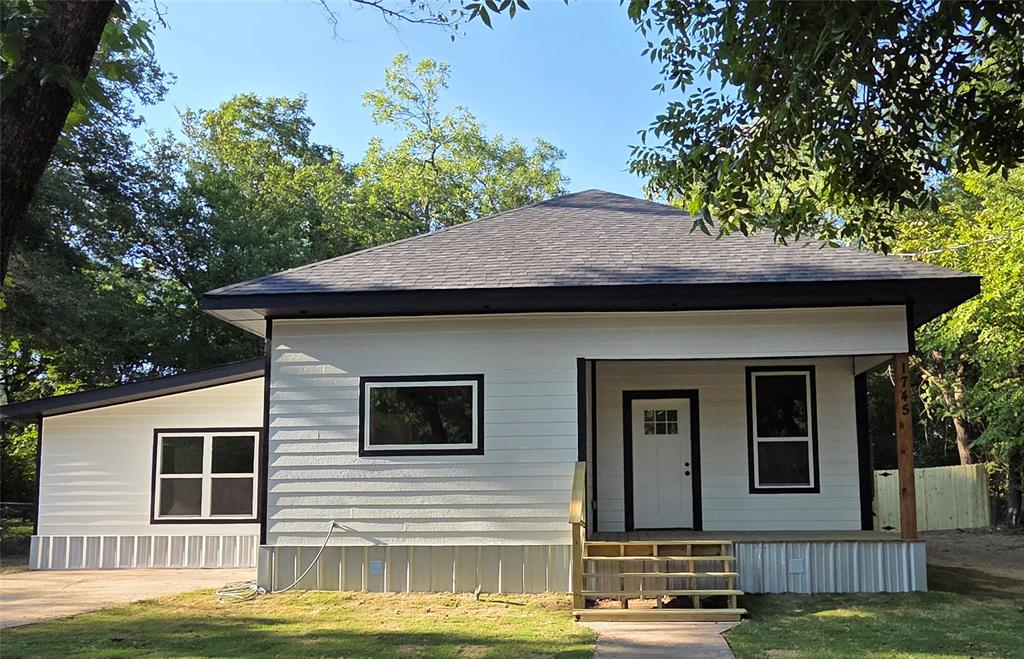 1745 East Cherry Street Paris, TX 75460 - Photo 4 of 40 a view of a house with a swimming pool