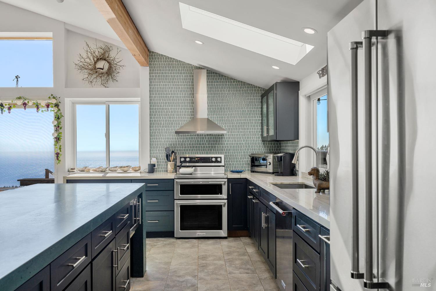 a kitchen with stainless steel appliances a sink stove and cabinets
