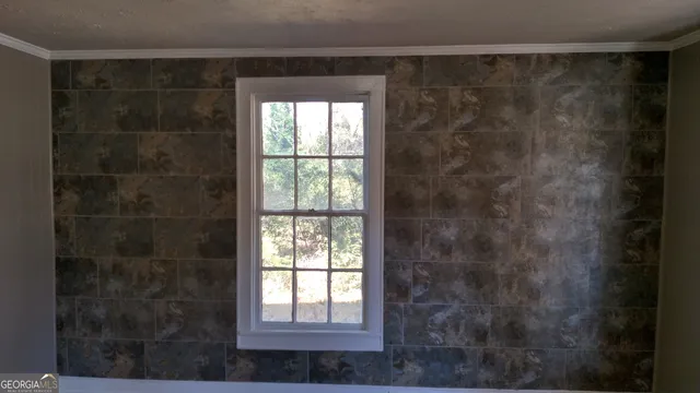 a view of a room with wooden floor and window