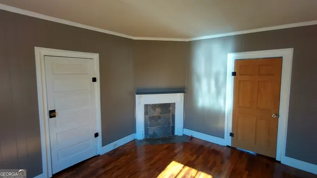 a view of entryway and hall with wooden floor