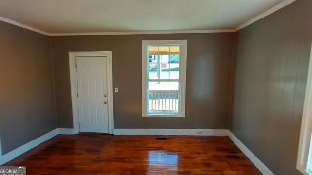 a view of a room with wooden floor