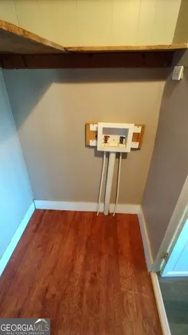 a view of a room with wooden floor