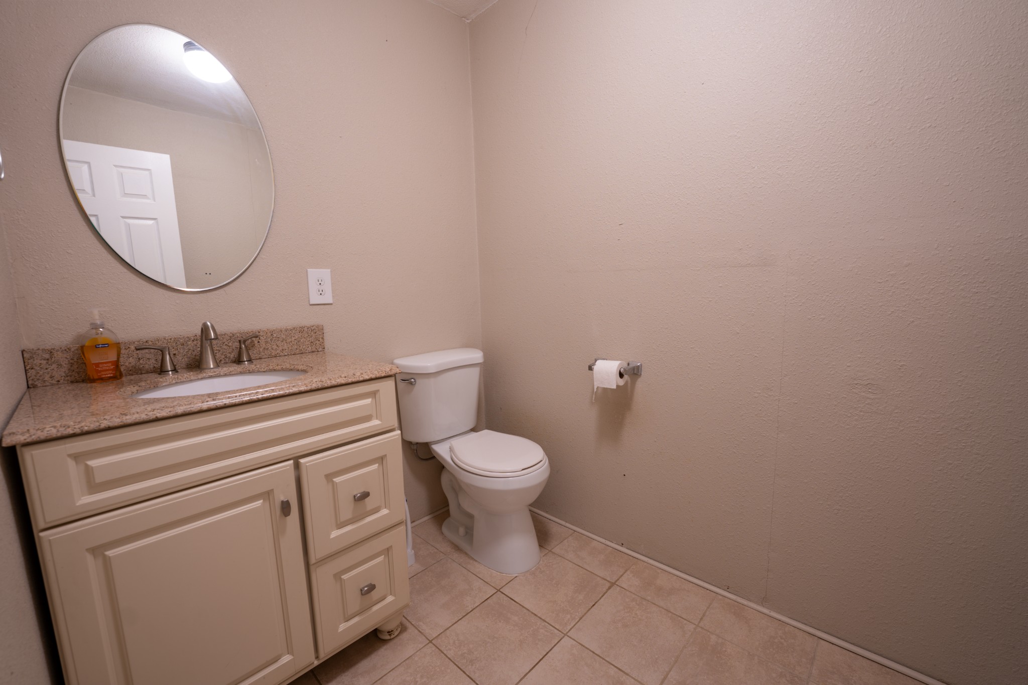 8247 Pinewood Road Nunnelly, TN 37137 - Photo 11 of 14 a bathroom with a granite countertop toilet a sink and a mirror