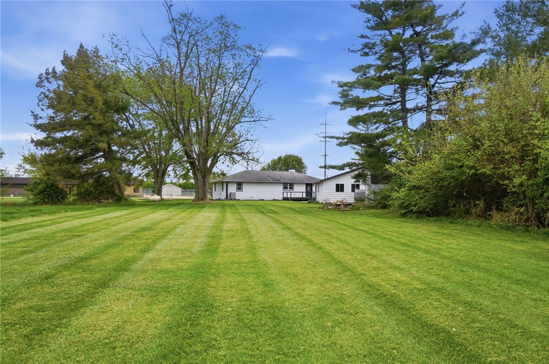 3991 Benner Road Miamisburg, OH 45342 - Photo 43 of 44 Expansive green lawn surrounds this charming home, offering ample space for outdoor enjoyment and relaxation.