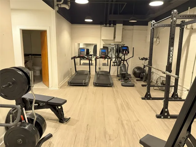 a room with gym equipment and a rug