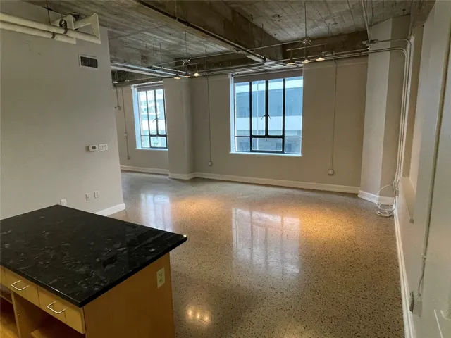 a kitchen with stainless steel appliances granite countertop a sink a stove and a refrigerator