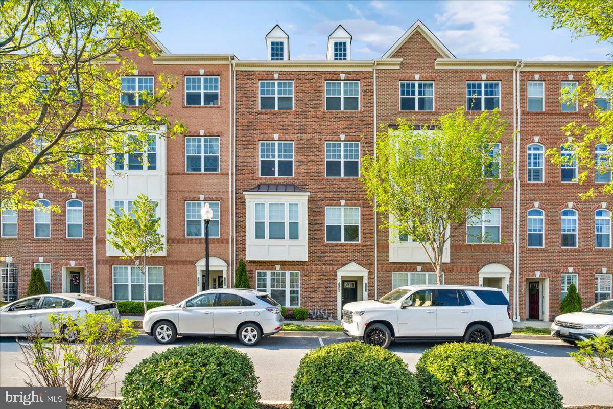 7142 Proclamation Place Frederick, MD 21703 - Photo 1 of 37 a front view of a residential apartment building with a yard