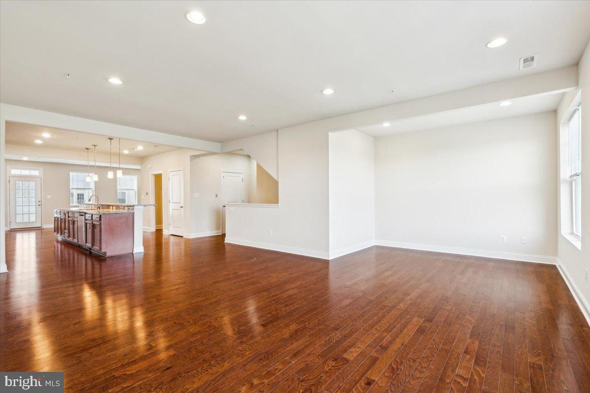7142 Proclamation Place Frederick, MD 21703 - Photo 11 of 37 a view of empty room with wooden floor