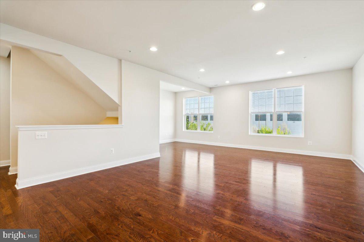 7142 Proclamation Place Frederick, MD 21703 - Photo 12 of 37 a view of an empty room with wooden floor and a window
