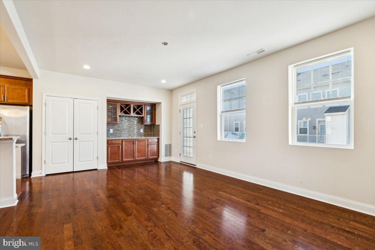 7142 Proclamation Place Frederick, MD 21703 - Photo 15 of 37 a view of a big room with wooden floor and windows