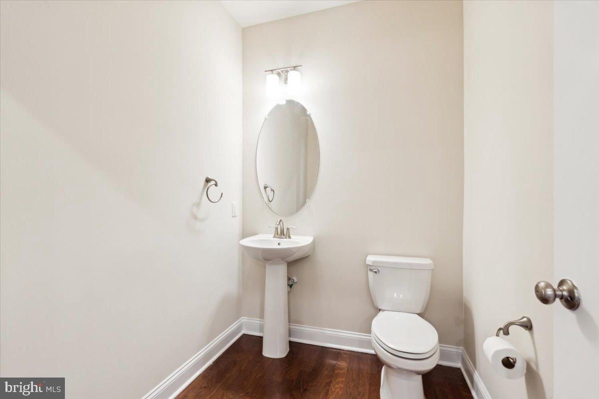 7142 Proclamation Place Frederick, MD 21703 - Photo 18 of 37 a bathroom with a toilet sink and mirror