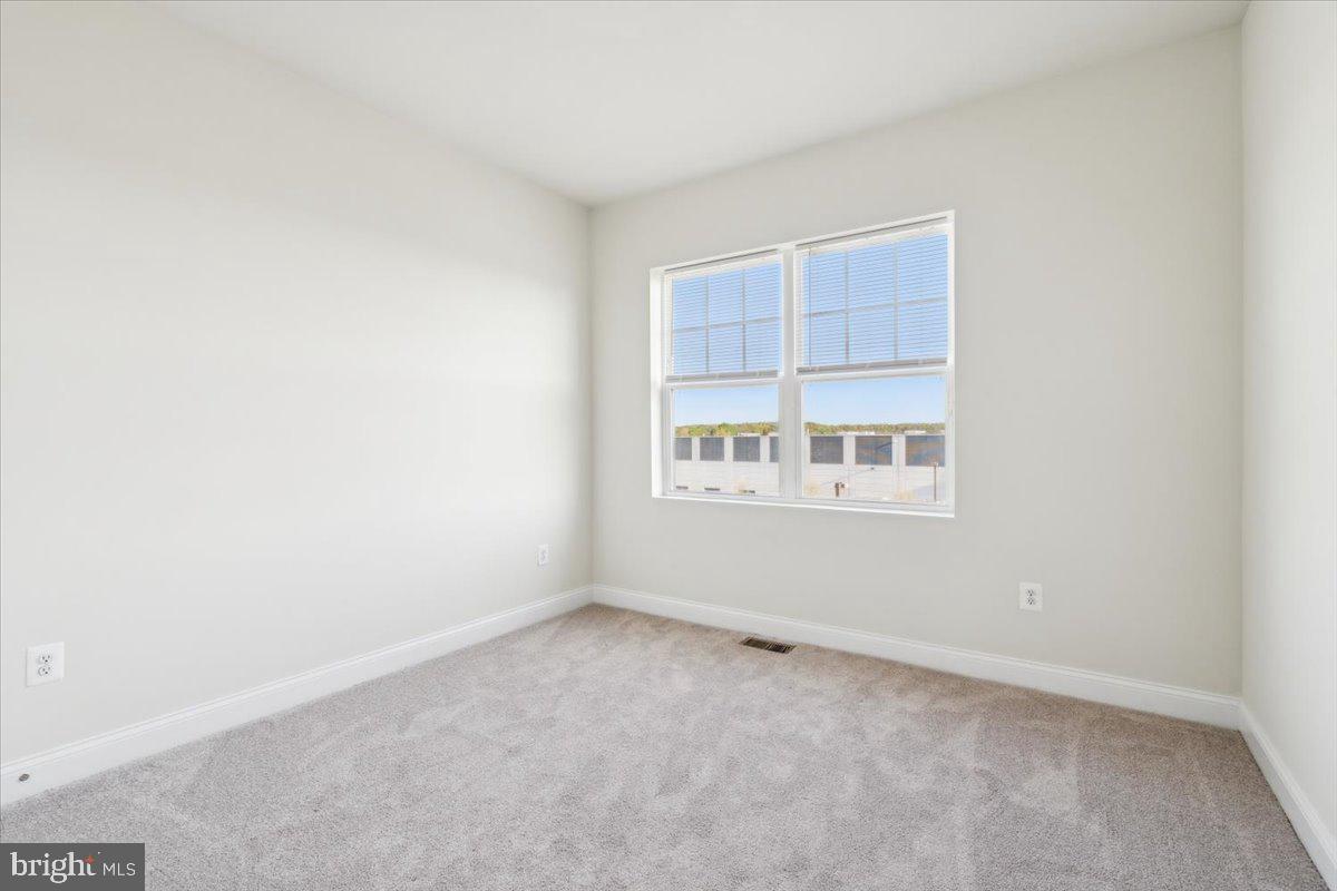 7142 Proclamation Place Frederick, MD 21703 - Photo 30 of 37 a view of an empty room with a window