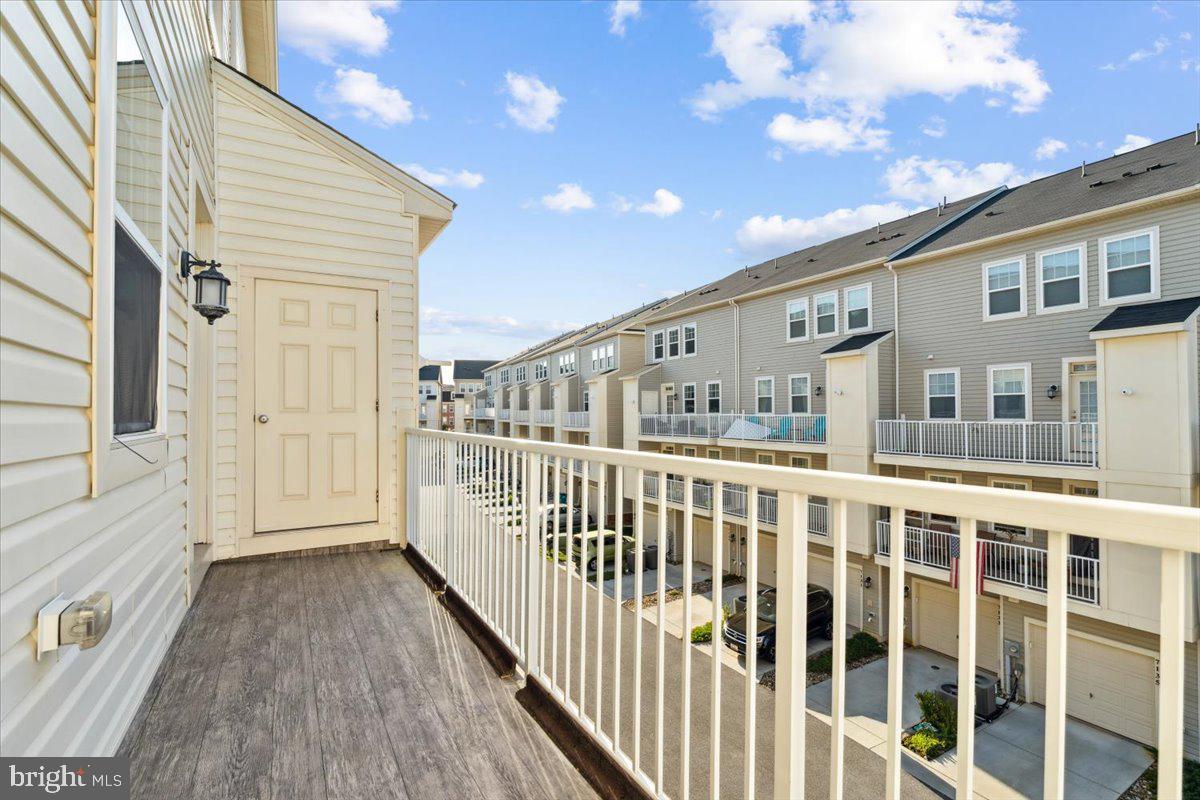7142 Proclamation Place Frederick, MD 21703 - Photo 32 of 37 a view of a balcony with wooden floor and fence