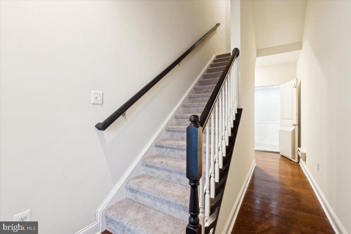 7142 Proclamation Place Frederick, MD 21703 - Photo 4 of 37 a view of staircase with wooden floor and white walls