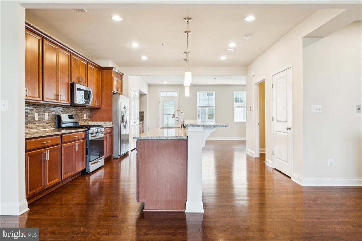 7142 Proclamation Place Frederick, MD 21703 - Photo 7 of 37 a view of kitchen with sink and wooden floor