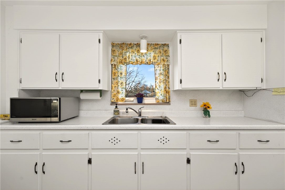 1237 Laurelwood Road Dayton, OH 45409 - Photo 13 of 56 This bright kitchen features ample cabinetry and a functional sink area, perfect for everyday living.