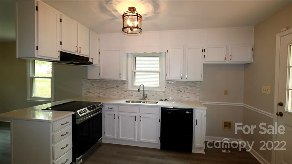 3612 Redstones Road Charlotte, NC 28212 - Photo 4 of 11 a kitchen with stainless steel appliances granite countertop a sink stove and cabinets