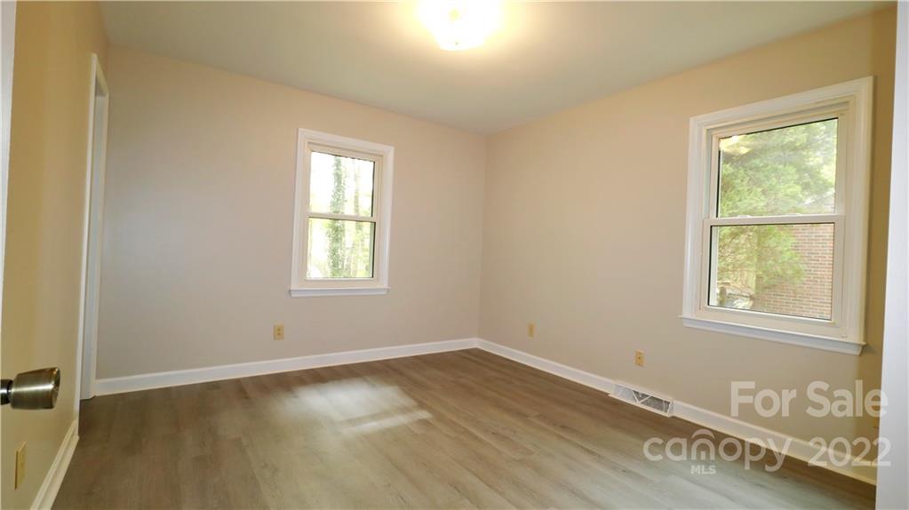 3612 Redstones Road Charlotte, NC 28212 - Photo 6 of 11 an empty room with wooden floor and windows