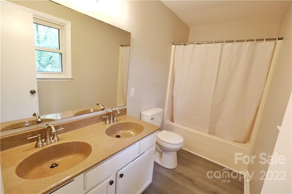 3612 Redstones Road Charlotte, NC 28212 - Photo 7 of 11 a bathroom with a sink toilet and shower