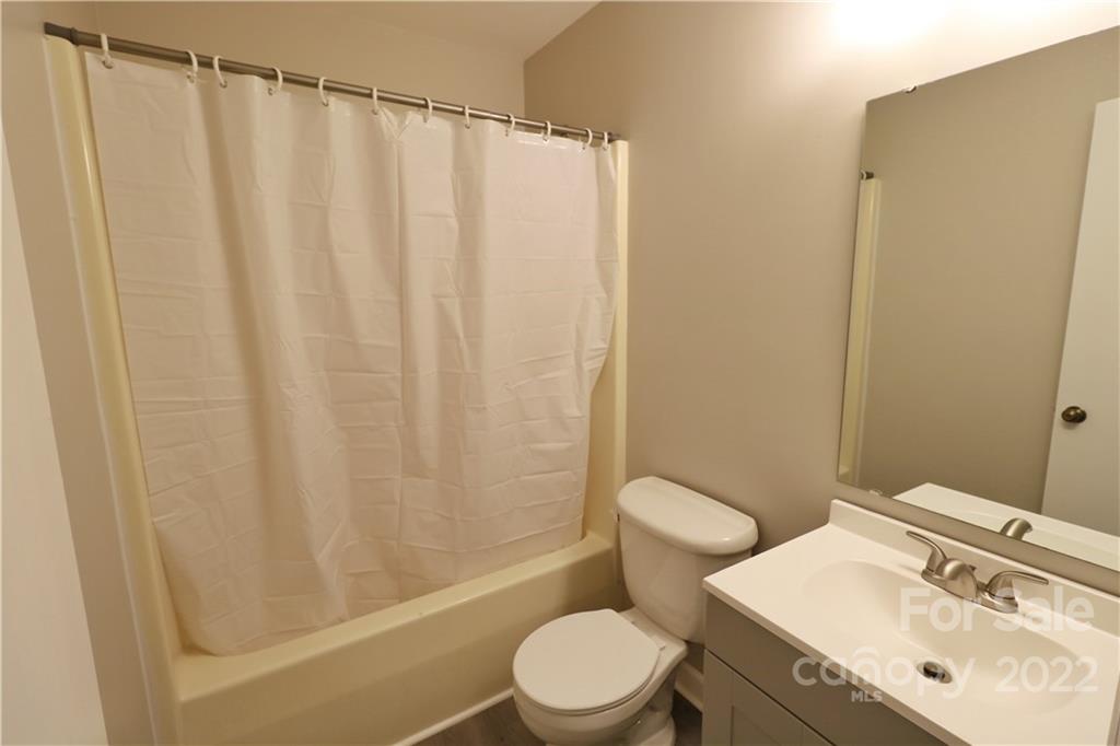 3612 Redstones Road Charlotte, NC 28212 - Photo 9 of 11 a bathroom with a sink a toilet and shower curtain