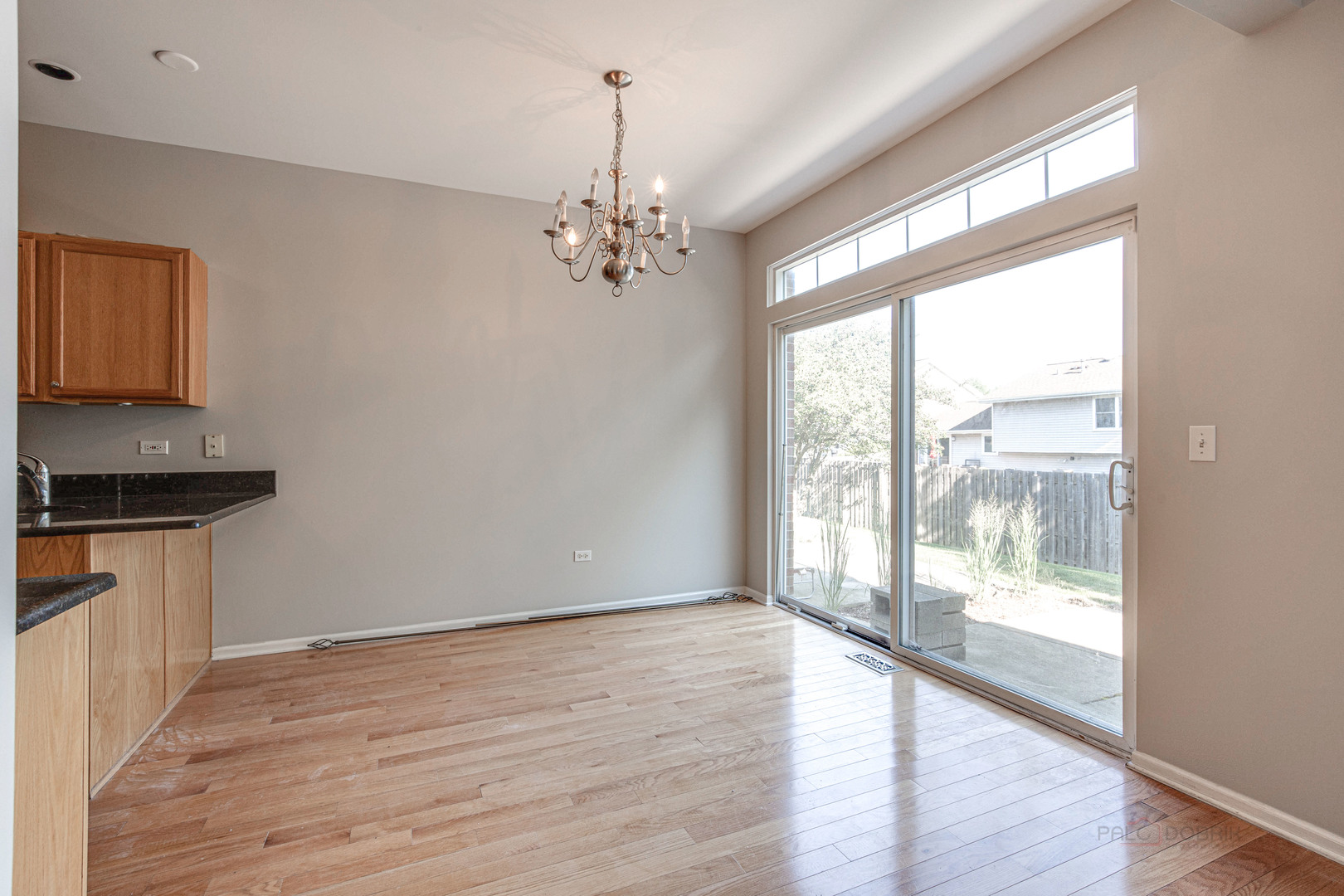 1655 Windward Court Naperville, IL 60563 - Photo 11 of 34 a view of an empty room with wooden floor and a window