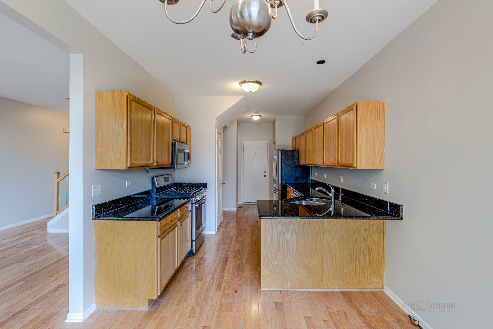 1655 Windward Court Naperville, IL 60563 - Photo 13 of 34 a kitchen with stainless steel appliances granite countertop a sink a stove and a wooden floors