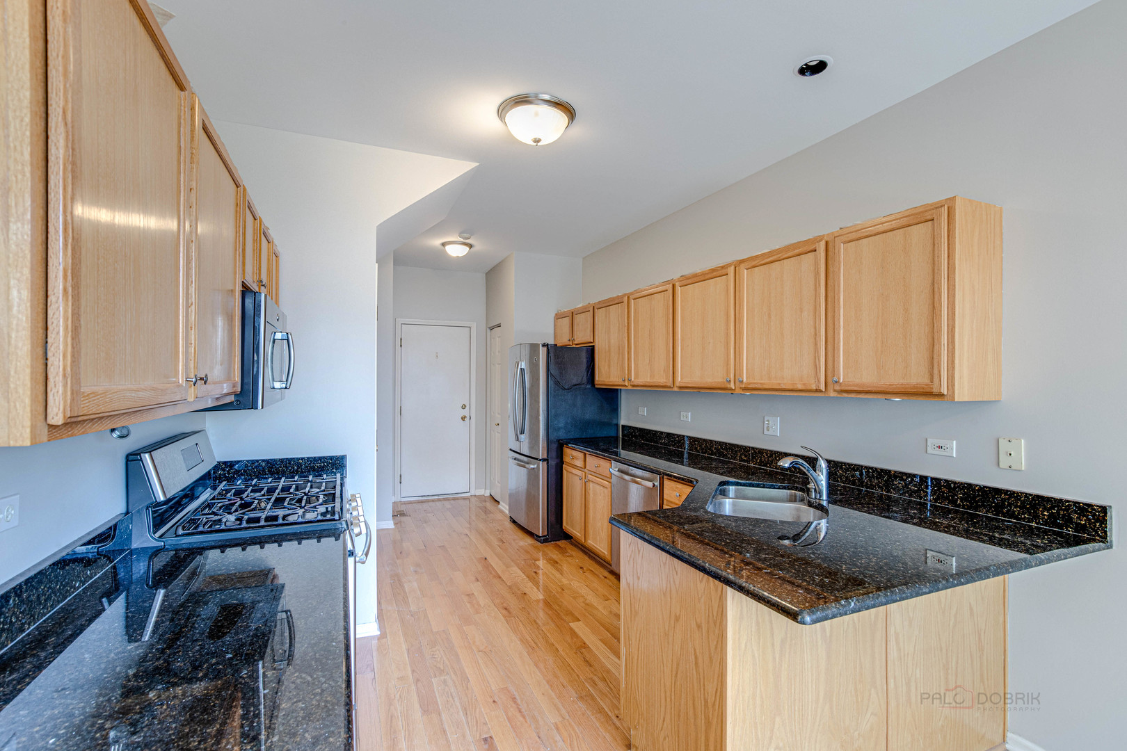 1655 Windward Court Naperville, IL 60563 - Photo 15 of 34 a kitchen with stainless steel appliances granite countertop a sink stove and cabinets