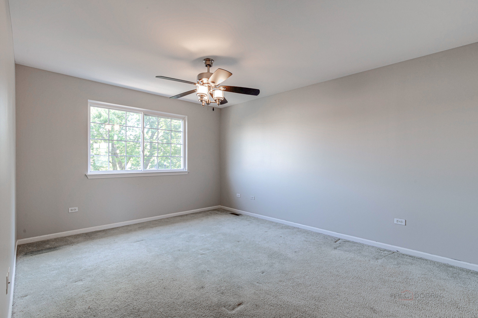 1655 Windward Court Naperville, IL 60563 - Photo 24 of 34 an empty room with windows and chandelier fan