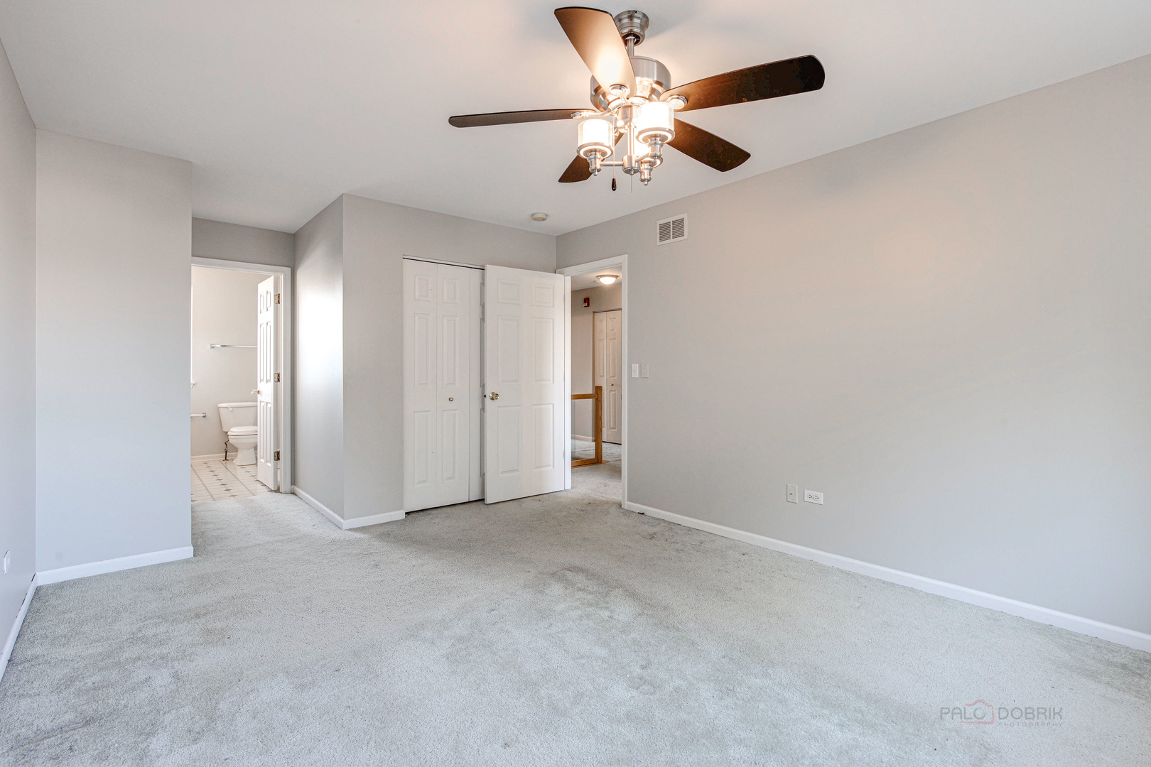 1655 Windward Court Naperville, IL 60563 - Photo 25 of 34 an empty room with a chandelier fan and windows