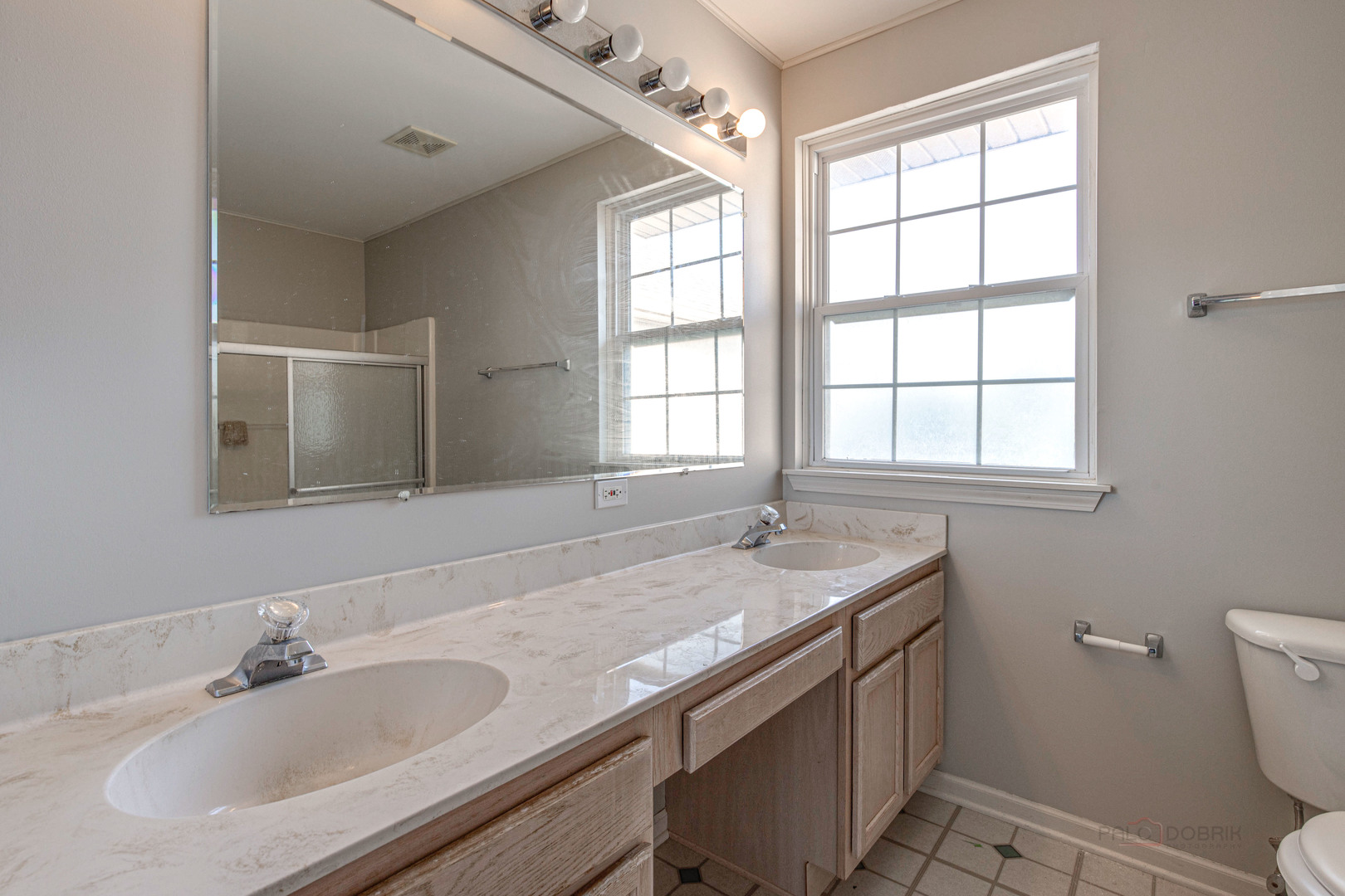 1655 Windward Court Naperville, IL 60563 - Photo 27 of 34 a bathroom with a granite countertop sink a toilet and a window
