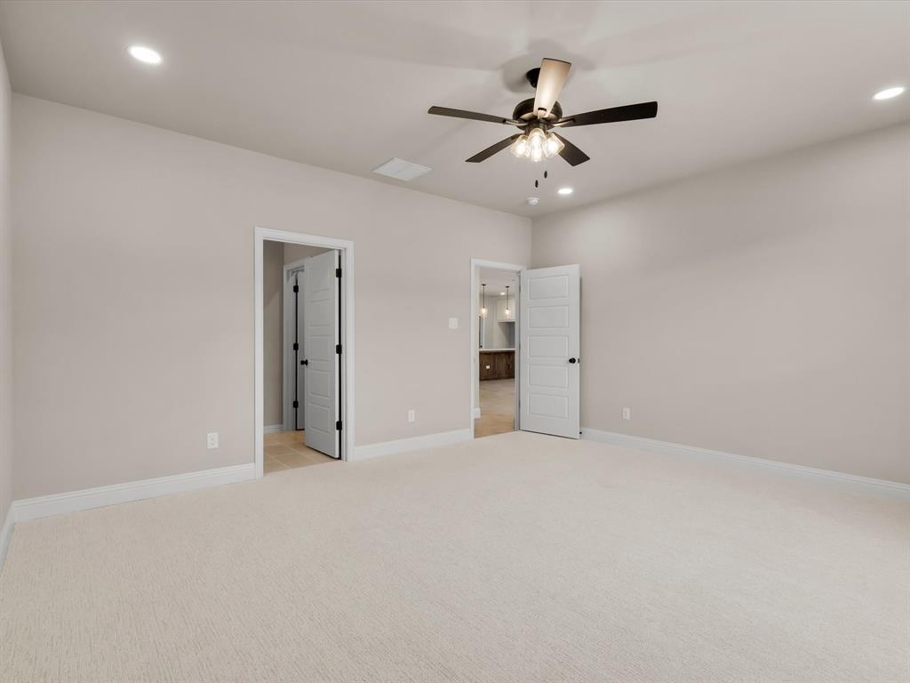 612 Jameson Springtown, TX 76082 - Photo 6 of 13 an empty room with chandelier fan and windows