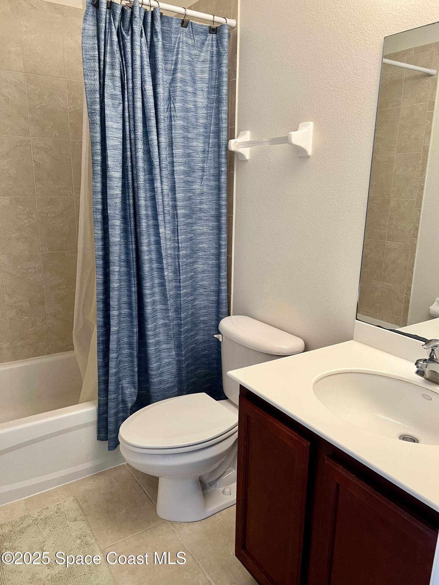 56 Piney Branch Way, Unit A Melbourne, FL 32904 - Photo 14 of 17 a bathroom with a sink a toilet and shower