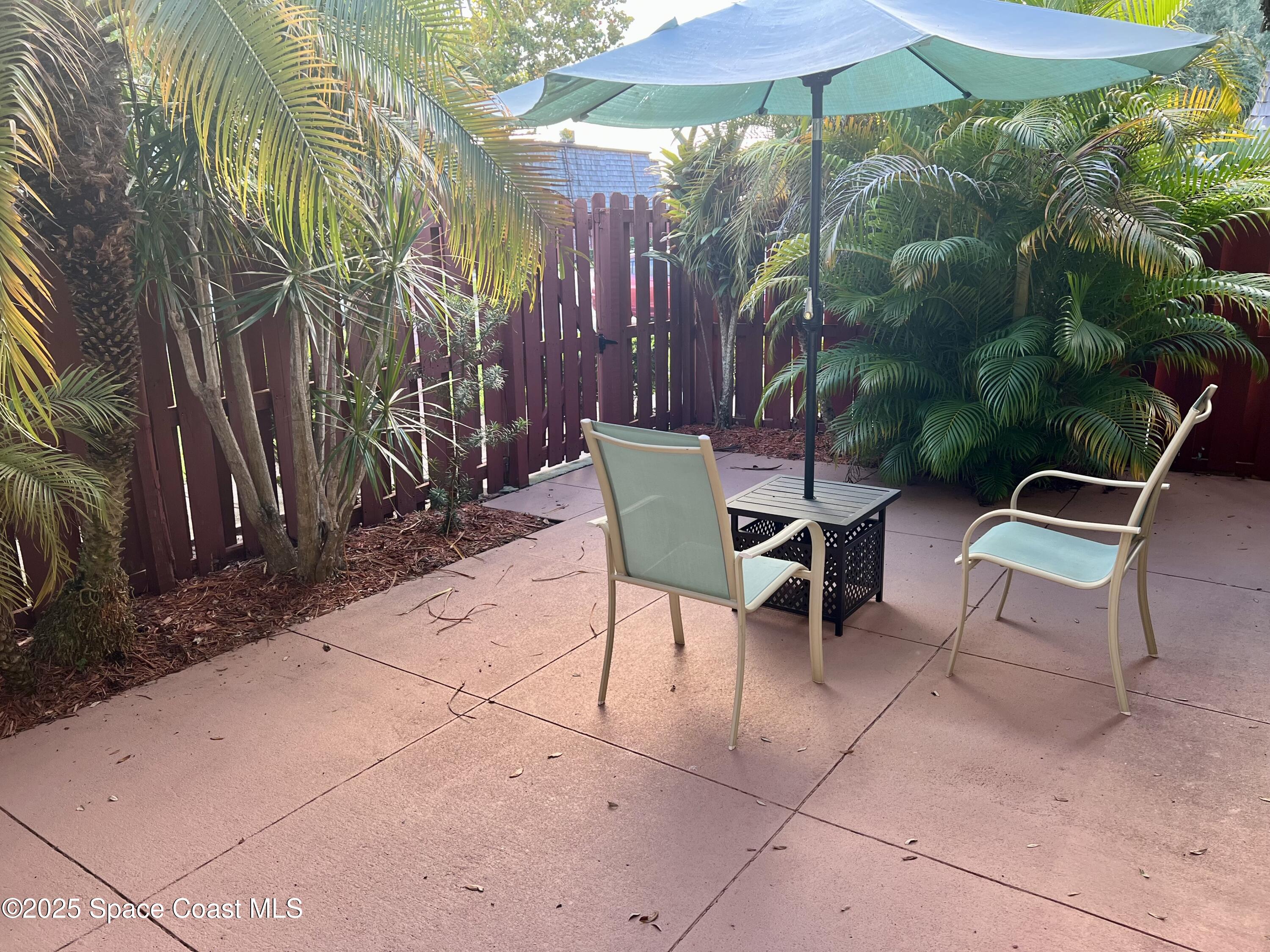 56 Piney Branch Way, Unit A Melbourne, FL 32904 - Photo 15 of 17 a view of a backyard with sitting area and furniture