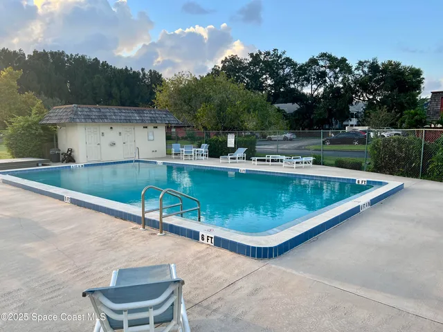 a view of a swimming pool with outdoor seating