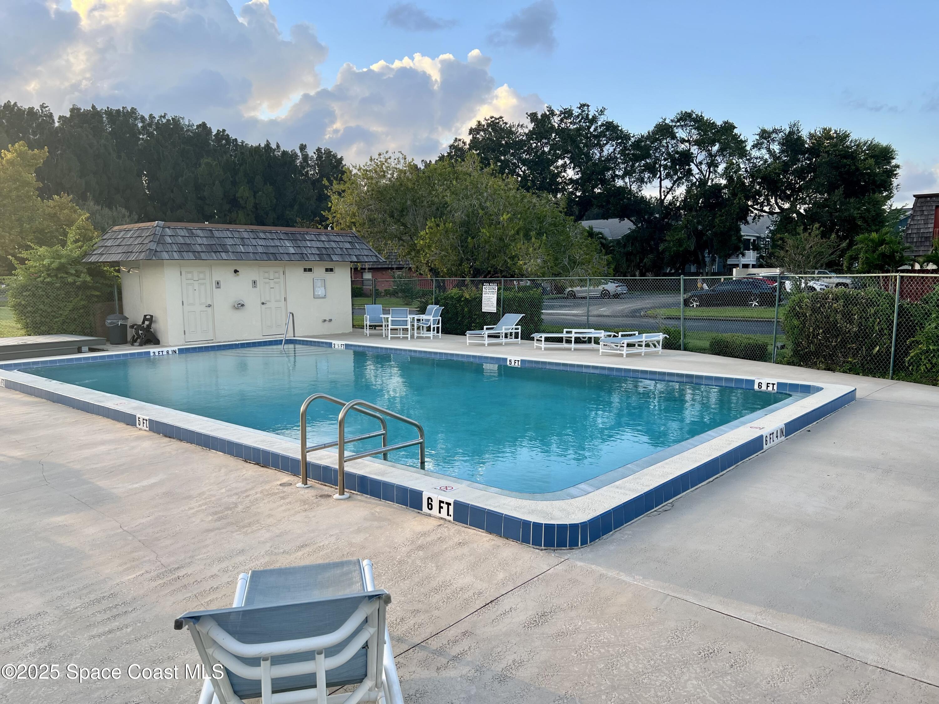 56 Piney Branch Way, Unit A Melbourne, FL 32904 - Photo 16 of 17 a view of a swimming pool with a patio