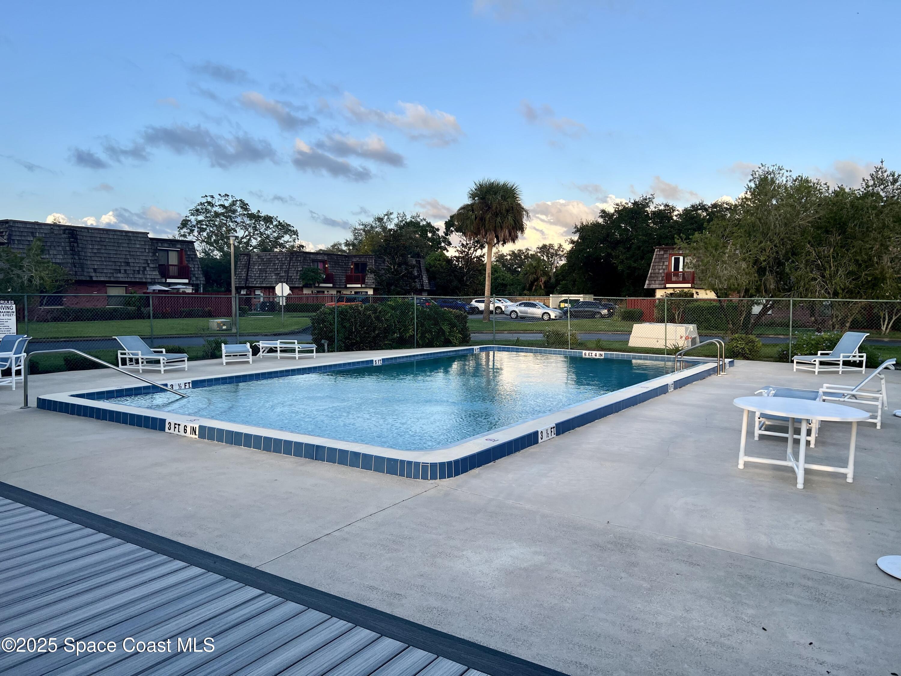 56 Piney Branch Way, Unit A Melbourne, FL 32904 - Photo 17 of 17 a view of a swimming pool with outdoor seating