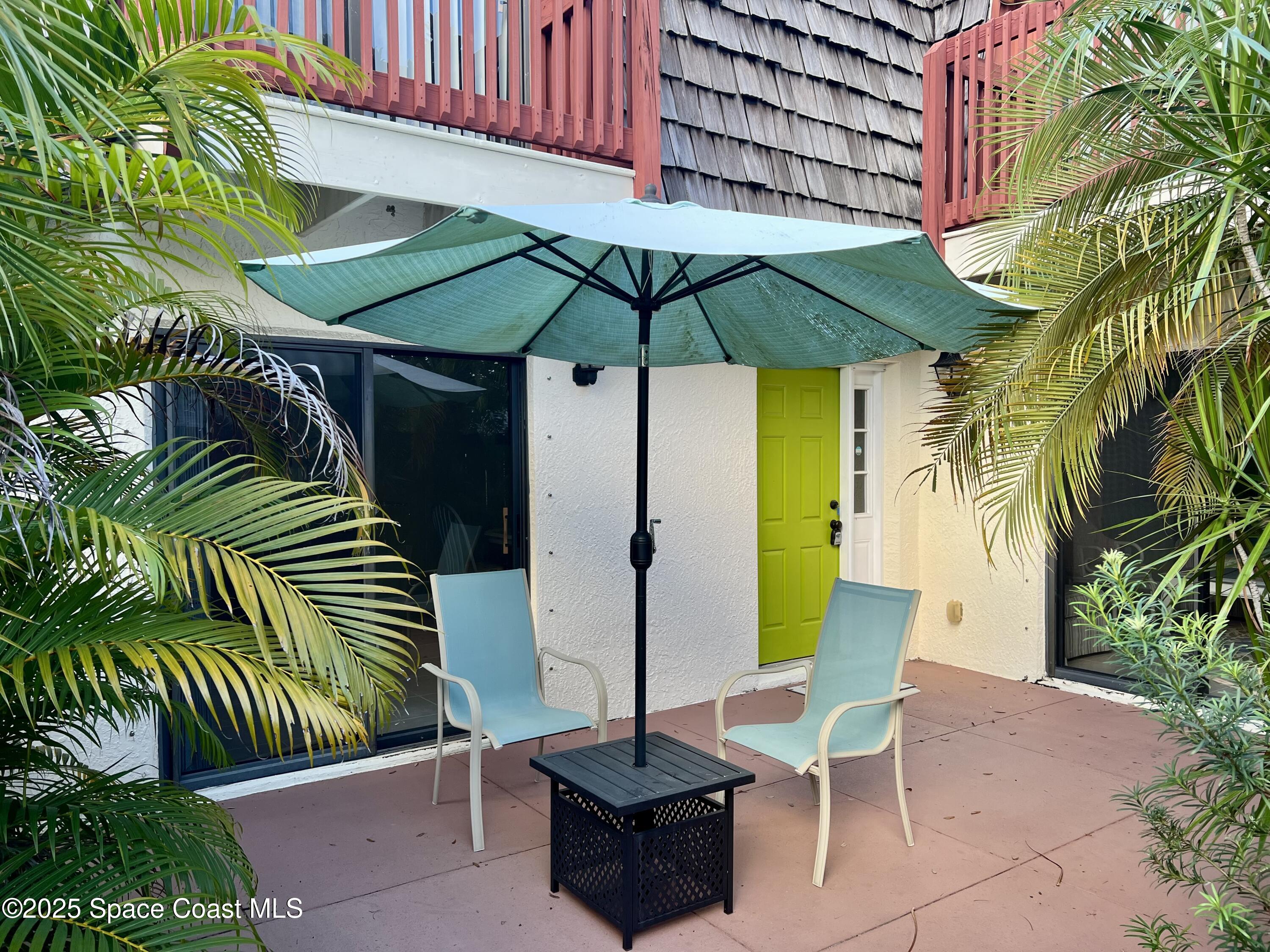 56 Piney Branch Way, Unit A Melbourne, FL 32904 - Photo 3 of 17 a chair and tables in the patio