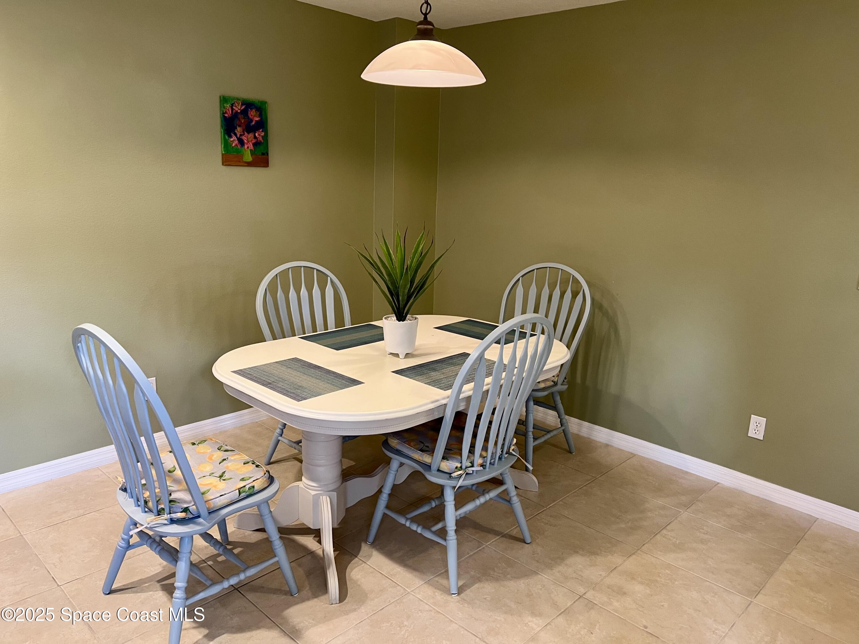 56 Piney Branch Way, Unit A Melbourne, FL 32904 - Photo 7 of 17 a view of a dining room with furniture and window