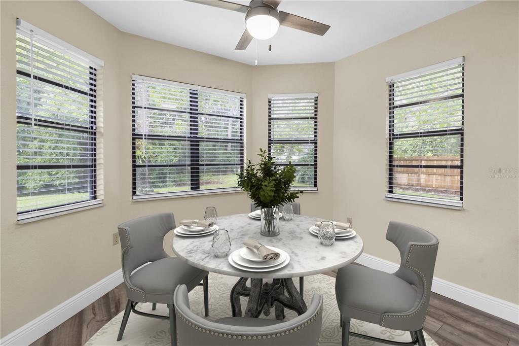 7230 Hummingbird Lane New Port Richey, FL 34655 - Photo 15 of 41 a view of a dining room with furniture window and wooden floor