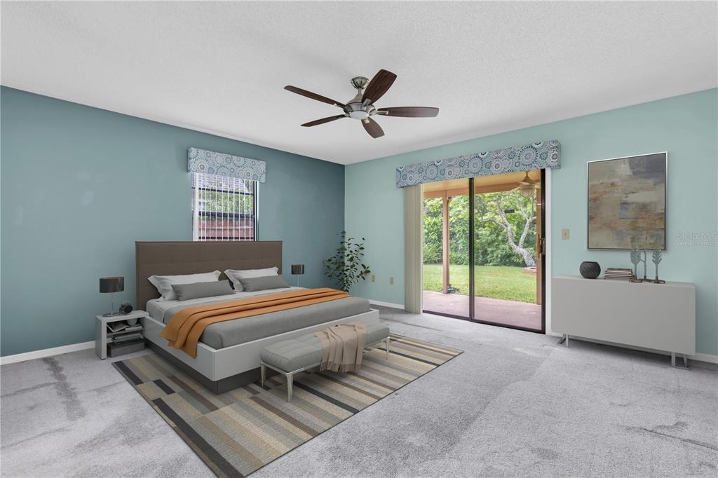 7230 Hummingbird Lane New Port Richey, FL 34655 - Photo 16 of 41 a bedroom with a bed and a large window