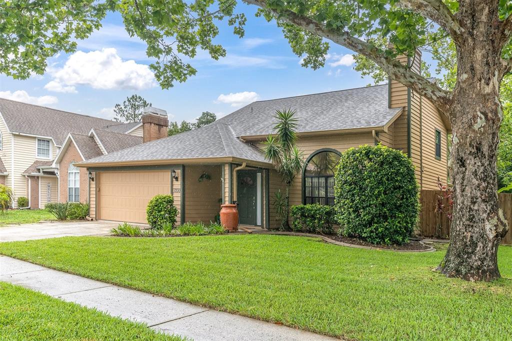 7230 Hummingbird Lane New Port Richey, FL 34655 - Photo 2 of 41 a front view of a house with garden