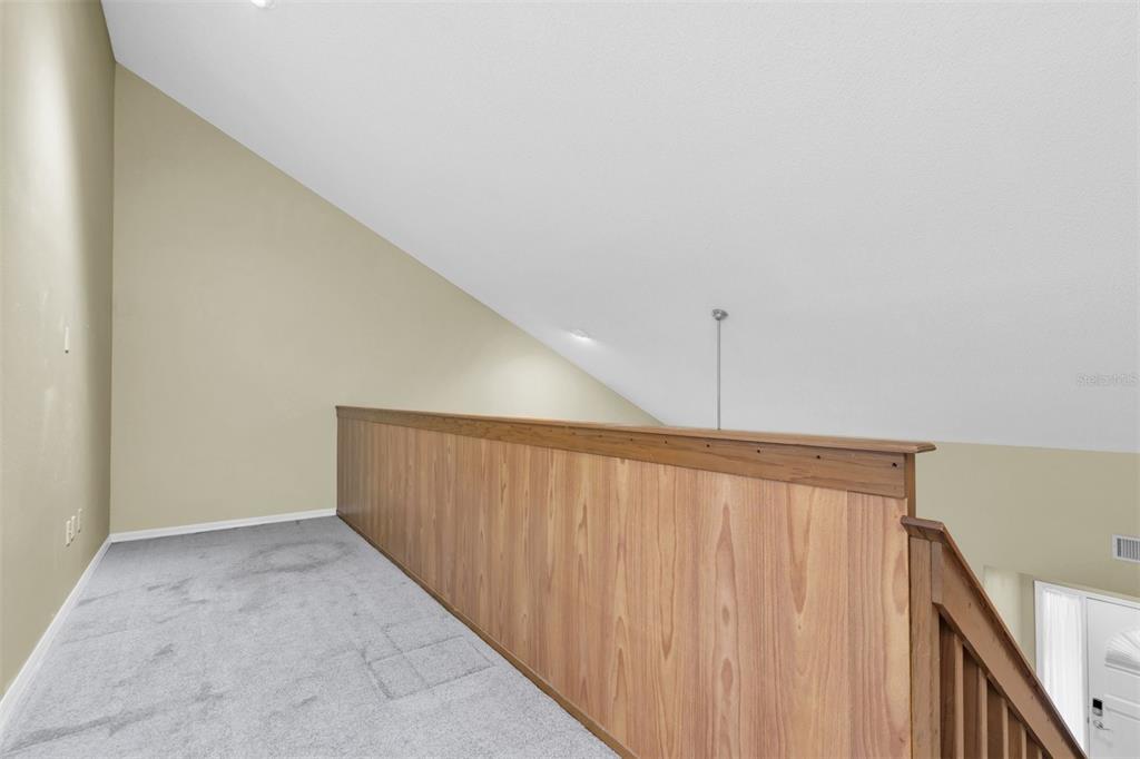 7230 Hummingbird Lane New Port Richey, FL 34655 - Photo 21 of 41 a view of a hallway with stairs