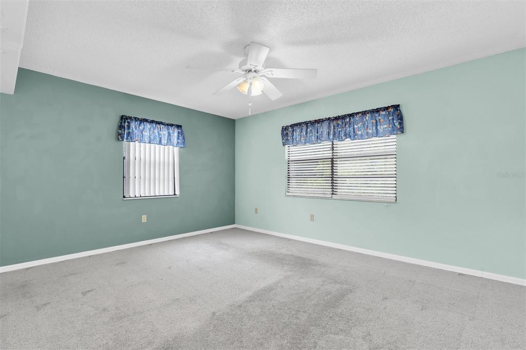 7230 Hummingbird Lane New Port Richey, FL 34655 - Photo 22 of 41 an empty room with a window and ceiling fan