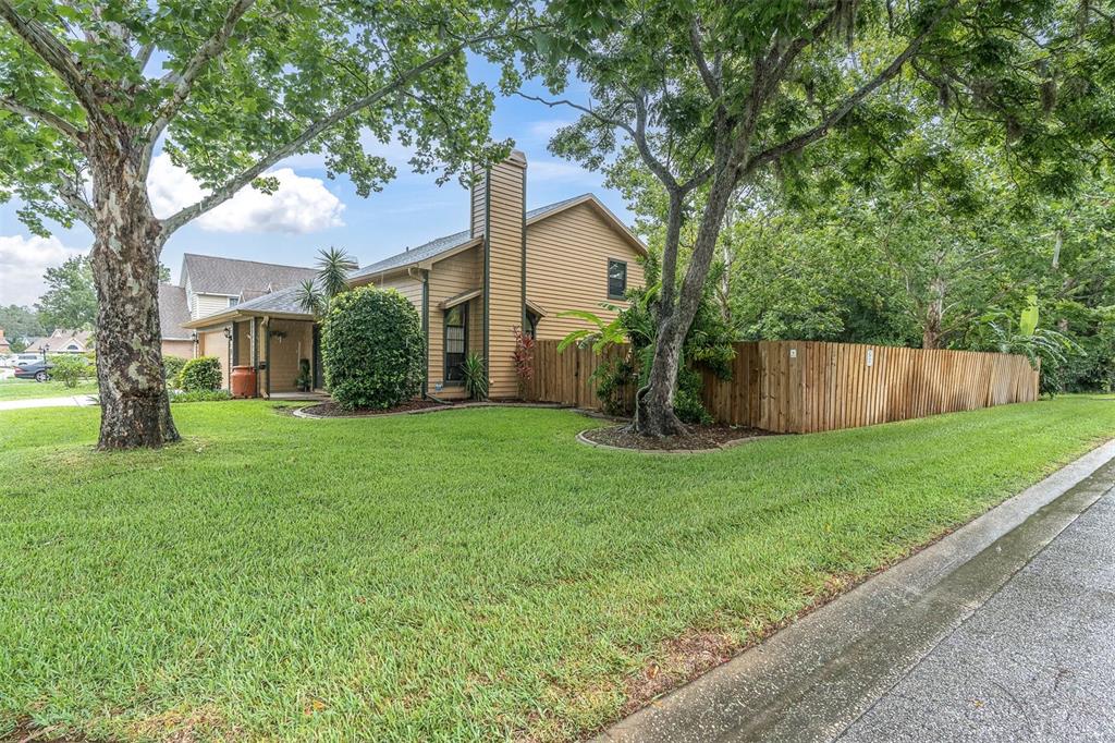 7230 Hummingbird Lane New Port Richey, FL 34655 - Photo 3 of 41 a front view of house with a garden