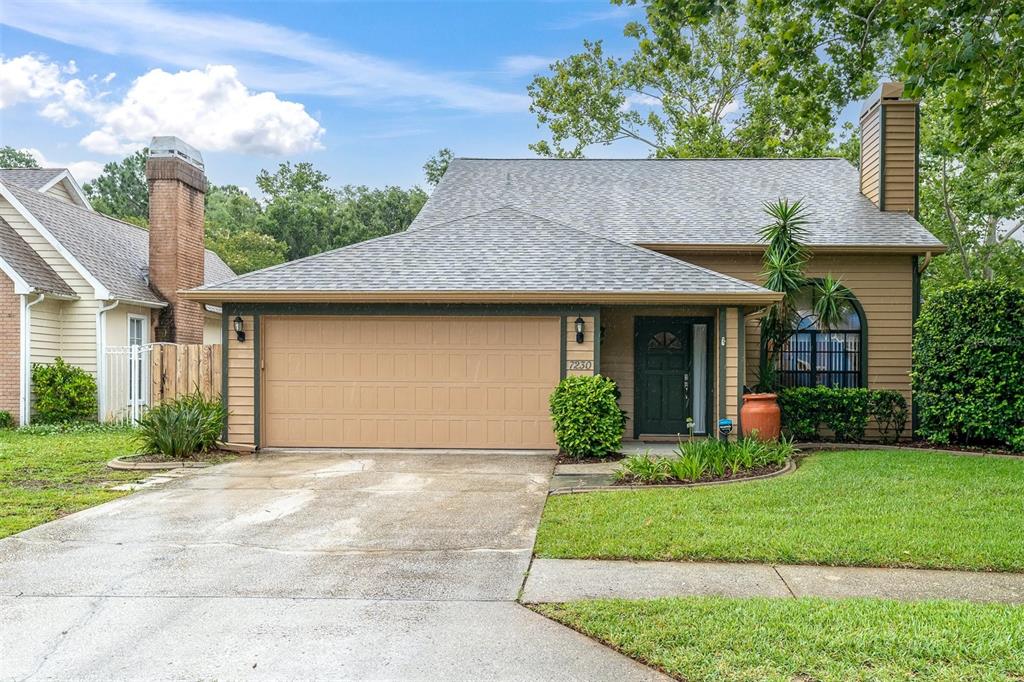 7230 Hummingbird Lane New Port Richey, FL 34655 - Photo 40 of 41 a front view of a house with garden